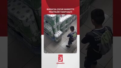 Henüz 10 yaşındaki bir çocuk, elindeki çakmakla raftaki etiketi yakıp