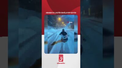 Dicle ilçesinde bir vatandaş, aracın arkasına bağladığı otomobil lastiğiyle karda